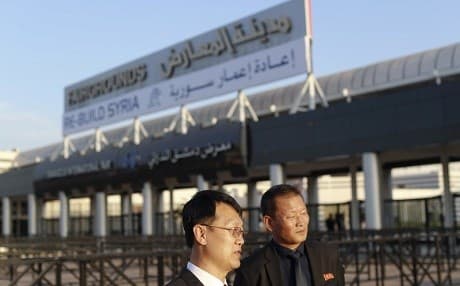 Chinese visitors arrive for the opening of the Syria rebuilding exhibition at the fair grounds in Damascus, Syria. Photo: Hassan Ammar/AP