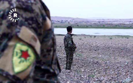 Kurdish YPG members of the SDF look out over the Euphrates River in Deir ez-Zor province. File photo: Rudaw