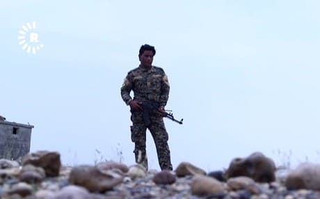 An SDF fighter looks out from a position in southern Deir ez-Zor province. File photo: Rudaw