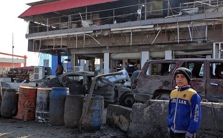 An Iraqi boy stands near a restaurant on November 9, 2018 at the scene of a car bomb explosion that killed three people and wounded a dozen in Iraq's Mosul yesterday, the first such attack since jihadists were ousted from the city last year. Photo: Zaid al-Obeidi/AFP