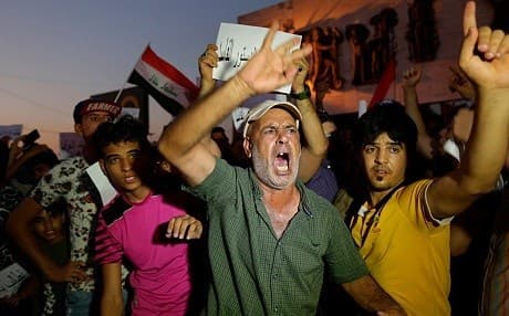 Protesters take to the streets to demand basic services and jobs in Basra in July 2018. File photo: Hadi Mizban/AP