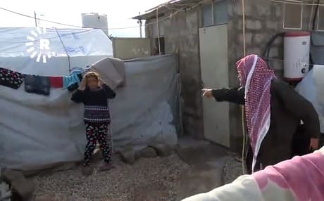 A displaced Yezidi man shows where they have been forced to hang their remaining belongings to dry after overnight flooding swept across northern Iraq and the Kurdistan Region on November 23, 2018. Photo: Rudaw TV