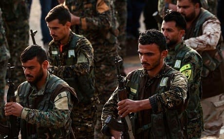 Syrian Kurdish members of the People's Protection Units (YPG) attend the funeral of a slain Kurdish commander in the northeastern city of Qamishli on December 6, 2018. Photo: Delil Souleiman/AFP