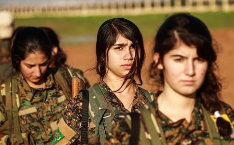 Fighters from the Kurdish Women's Projection Units (YPJ) attend the funeral of a member of the Syrian Democratic Forces (SDF) killed fighting ISIS in Hajin. Photo: Delil Souleiman/AFP