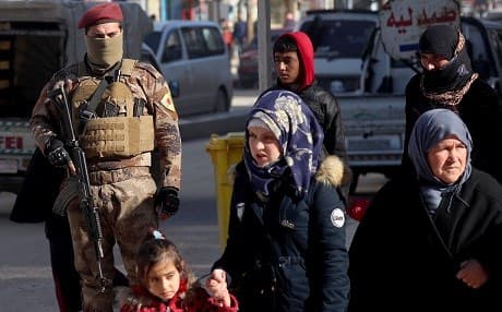 Forces of the Manbij Military Council are on guard in the city’s bazaar on December 29, 2018. Photo: Delil Souleiman/AFP
