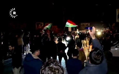 Revelers celebrated raising the Kurdistan flag at the PUK office in Kirkuk on Tuesday night. Photo: Rudaw 