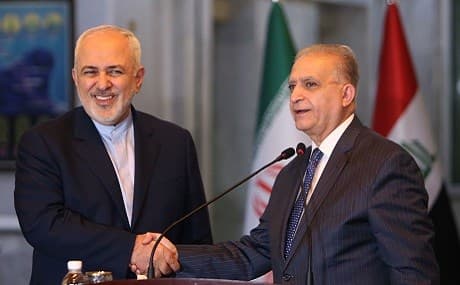 Iranian Foreign Minister Mohammad Javad Zarif (L) and Iraqi Foreign Minister Mohammad Ali al-Hakim shake hands following a joint press conference during an official visit to Baghdad, January 13, 2019. Photo: Sabah Arar / AFP 