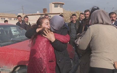A woman recently rescued from ISIS, with her face covered, embraces friends and relatives in Duhok. Photo: Rudaw