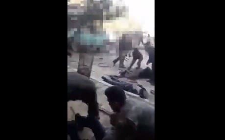 An image grab from a video supplied to Rudaw shows people help those injured in a bombing in central Afrin on Sunday. 