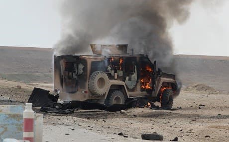 A military vehicle is on fire at the scene of a suicide car bomb attack on a military convoy on a road in Syria's northeastern Hasaka province, which killed five SDF on January 21, 2019. Photo: AFP