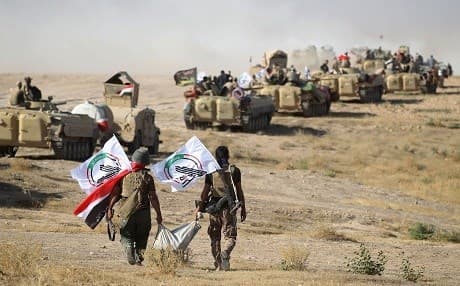 Members of the Hashd al-Shaabi advance on Tal Afar during the war against ISIS in August 2017. File photo: Ahmad al-Rubaye/AFP