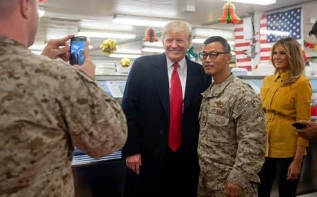 President Donald Trump and First Lady Melania Trump pose for a photo with US military personnel at al-Asad air base in Iraq on December 26, 2018. Photo: Saul Loeb/AFP