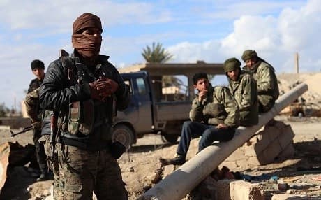 SDF fighters, pictured here on February 2, have been waiting near Baghouz to begin their last ground assault against ISIS in the village. Photo: Delil Souleiman/AFP