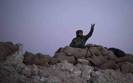 In this February 19, 2019 image a SDF fighter reacts as an airstrike hits territory still held by Islamic State militants in the desert outside Baghouz, Syria. File photo: Felipe Dana | AP
