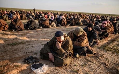 Men suspected of being Islamic State (ISIS) fighters wait to be searched by members of the Kurdish-led Syrian Democratic Forces (SDF) after leaving the IS group's last holdout of Baghouz, in Syria's northern Deir Ezzor province on February 22, 2019. Photo: AFP / Bulent KILIC