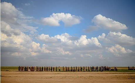 Men walk towards an area controlled by fighters of the US-backed Syrian Democratic Forces (SDF) after leaving the Islamic State (IS) group's last holdout of Baghouz, in Syria's northern Deir ez-Zor province, February 22, 2019. Photo: Bulent Kilic / AFP