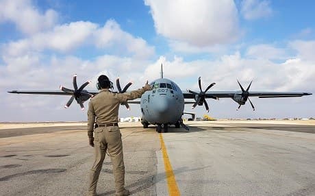 A Canadian Armed Forces member signals the all clear to a Canadian cargo plane to take off from an undisclosed air field in the Middle East: Photo: Royal Canadian Air Force