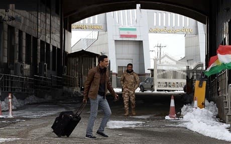 A traveler wheels his suitcase at the Kurdistan Region-Iran border. File photo: Safin Hamed/AFP