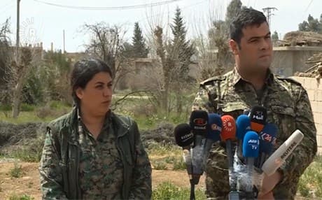Kino Gabriel (right), the spokesperson for the Syrian Democratic Forces, delivers a press conference to reporters in Deir ez-Zor governorate, Syria, on March 17, 2019