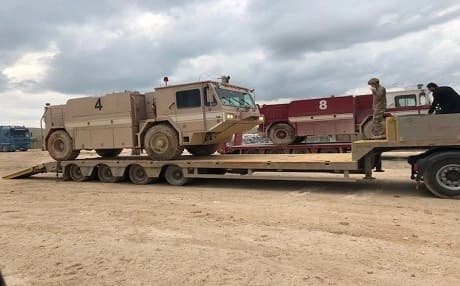 Staff Sgt. Clayton Navaezlugo with the 620th Movement Control Team provides guidance during the loading of a firetruck for transport in Southwest Asia on March 8, 2019. Photo: 1st Lt. Bryce Barbosa | US Army