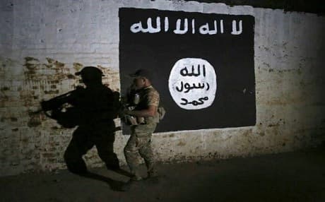 In this March 1, 2017 image, an Iraqi soldier inspects a recently-discovered train tunnel, adorned with an ISIS flag in western Mosul, Iraq. File photo: Khalid Mohammed | AP