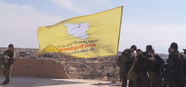 The flag of the Syrian Democratic Forces (SDF) flies over Baghouz on March 23, 2019. Photo: screengrab/AFP video