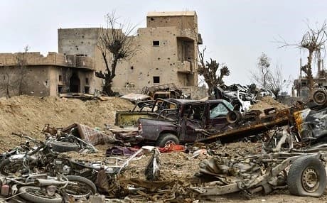 This picture taken on March 24, 2019 shows destroyed vehicles and damaged buildings in the village of Baghouz in Syria. File photo: Giuseppe Cacace | AFP