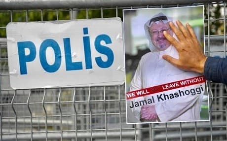 A poster featuring slain Washington Post columnist Jamal Khashoggi is affixed to a police barrier outside the Saudi consulate in Istanbul, Turkey. File photo: AFP