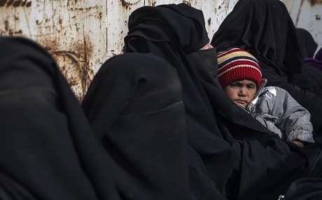 Women and children fleeing ISIS' last holdout in Baghouz, Syria sit in the back of a truck on February 14, 2019. Photo: Fadel Senna/AFP