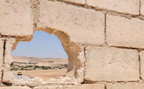 Turkish forces are seen in the distance during an independent, coordinated patrol by US forces outside Manbij, Syria on July 22, 2018. Photo: Sgt. Nicole Paese | US Army