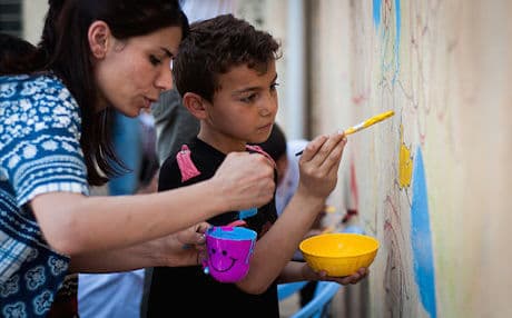 Sushma Legendre McIntosh, a French art therapist, says activities like the mural project have both short-term and long-term therapeutic benefits for children living in refugee camps. Photo by Kira Walker