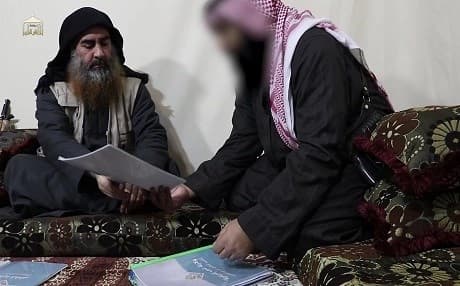 In this undated and unlocated TV grab taken from a video released by Al-Furqan media, the chief of ISIS Abu Bakr al-Baghdadi (L) appears for the first time in five years in a propaganda video. Photo: AFP/Al Furqan