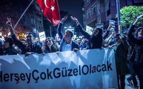 Protesters hold a placard that reads "Everything is going to be very good" during a demonstration in Istanbul, on May 8, 2019, following a decision by the authorities to re-run the city's mayoral election. Photo: Bulent Kilic/AFP