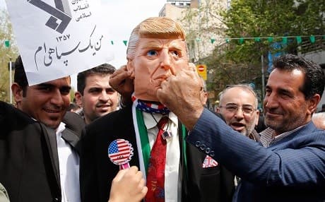 Iranians pretend to punch a man wearing a Trump mask at an anti-US rally in Tehran on April 12, 2019 condemning Washington's decision to blacklist the IRGC. Photo: AFP
