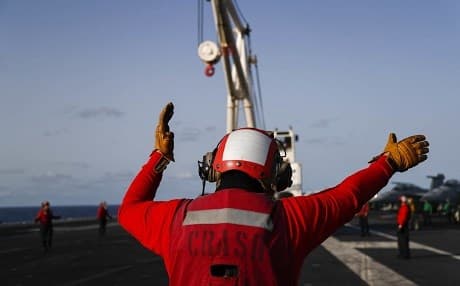 Crew direct an aircraft crash and salvage crane on the flight deck of aircraft carrier USS Abraham Lincoln in the Gulf of Aden on May 14, 2019. The carrier has been deployed to Middle Eastern waters amid heightened tensions between the US and Iran. Photo: Mass Communication Specialist Seaman Michael Singley/US Navy