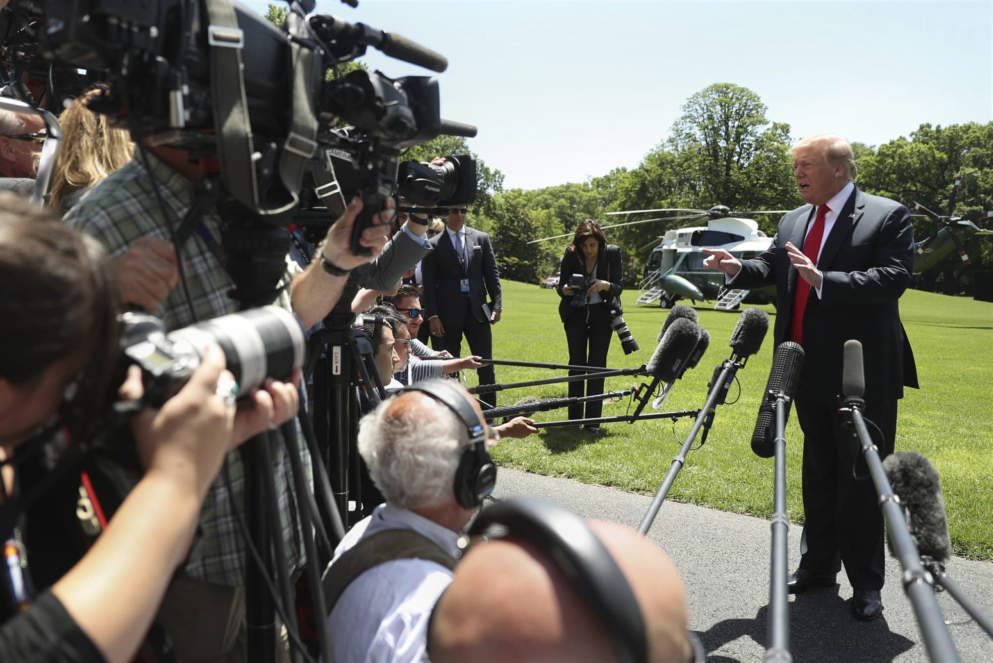 Trump speaks to reporters on the White House lawn as he heads out on a trip to Japan. Photo:AP