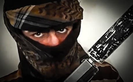 A man poses with a silenced pistol in a still taken from a recent Ramadan video published by the Islamic State group (ISIS). Photo: ISIS media / Telegram 