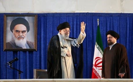 Iranian Supreme Leader Ayatollah Ali Khamenei waving near Hassan Khomeini, the grandson of former Iranian supreme leader Ayatollah Ruhollah Khomeini, during the 30th death anniversary of the latter, at his shrine in Tehran on June 4, 2019. Photo: AFP/Khamenei.ir handout