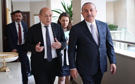 A handout photo released by Turkey shows Turkish Foreign Minister Mevlut Cavusoglu (right) walking next to his French counterpart Jean-Yves Le Drian during their meeting in Ankara, on June 13, 2019. Photo: AFP/Turkish MFA handout