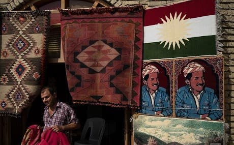 A man sells rugs depicting the Kurdistan Region’s former president Masoud Barzani in central Erbil, Iraq, October 25, 2017. File photo: Felipe Dana / AP