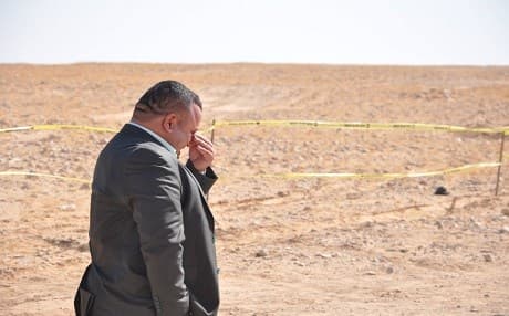 An official breaks down at a mass grave site in Samawa, southwestern Iraq, on July 23, 2019. Photo: Fuad Taha 