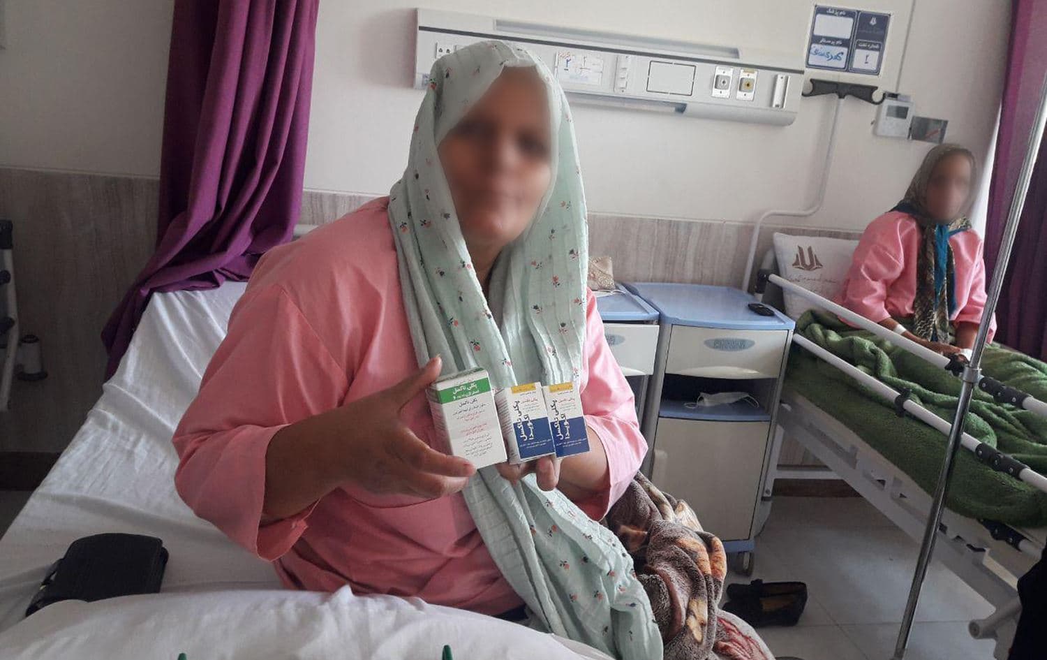 A woman holds her cancer medication in Tawhid Hospital in Sanandaj, Iran in August 2019. Photo: Rudaw English
