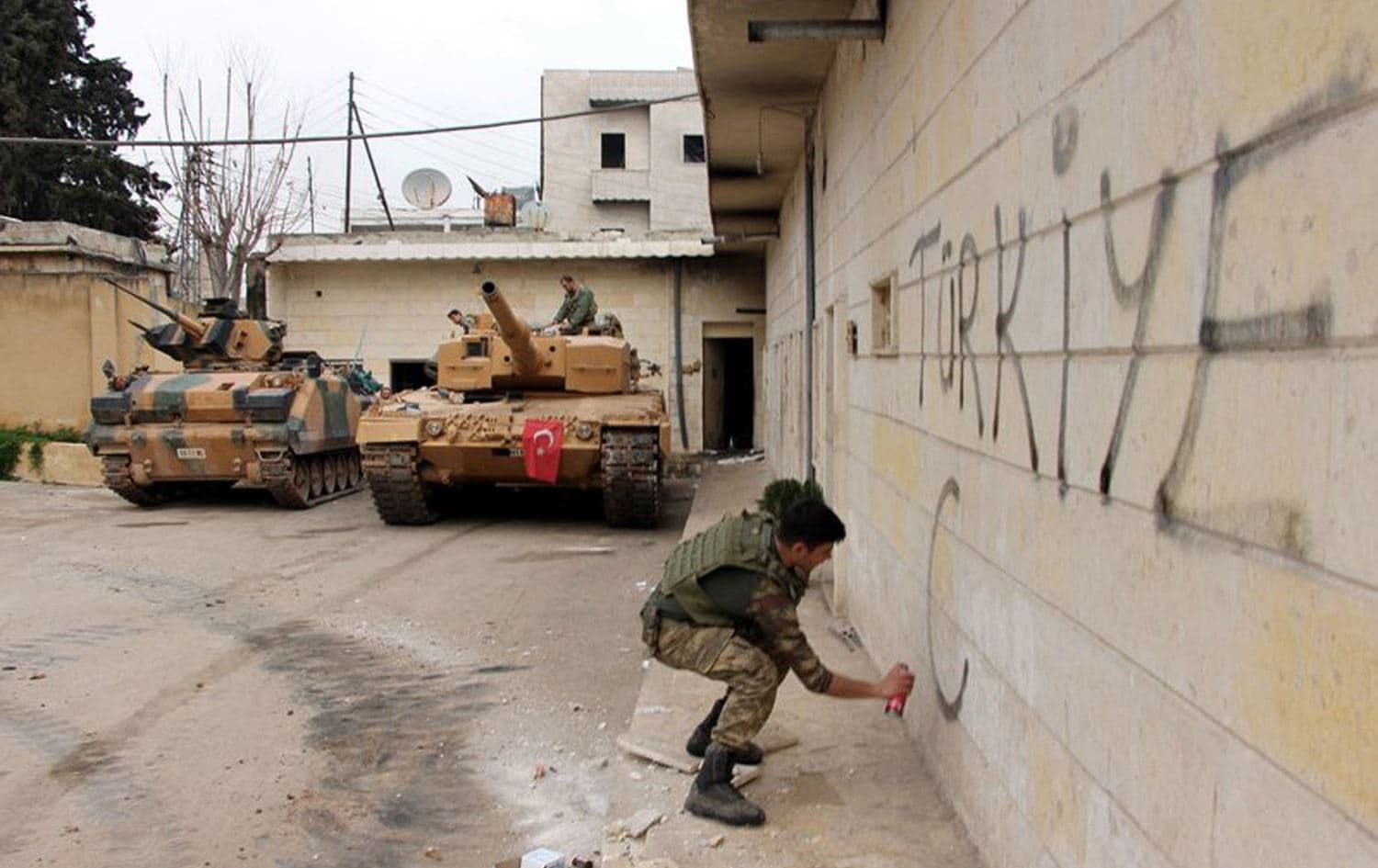 A Turkish soldier writes "Turkey" on a wall in the city center of Afrin, northwest Syria, March 18, 2018. File photo:  Hasan Kırmızitaş / DHA-Depo Photos / AP 