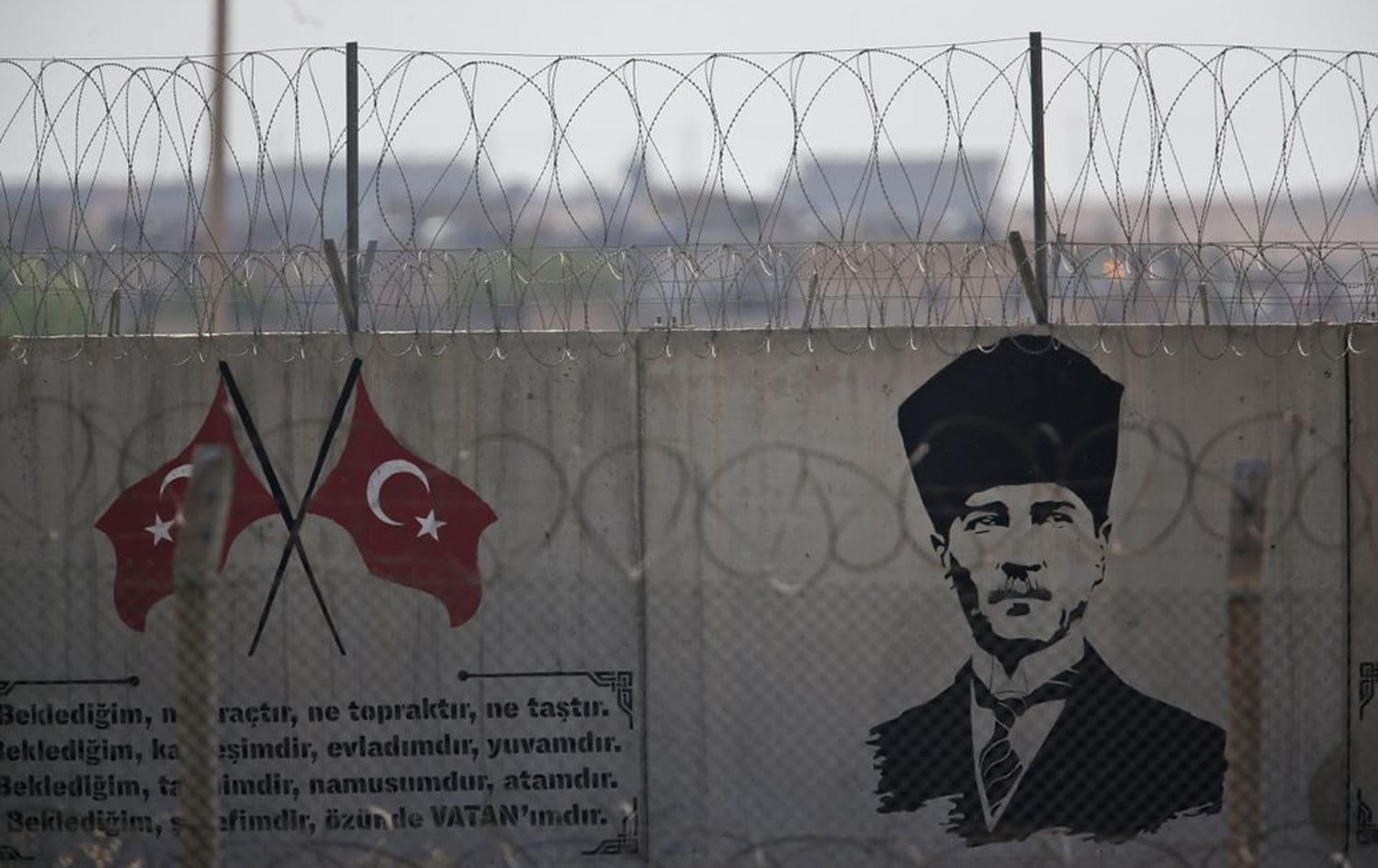 A graffiti of modern Turkey's founder Mustafa Kemal Ataturk is seen on the Turkish side of the border between Turkey and Syria, in Akcakale, Sanliurfa province, southeastern Turkey, October 8, 2019. Photo: Lefteris Pitarakis / AP