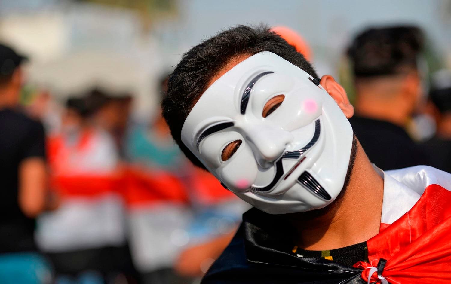 An Iraqi protester wearing a Guy Fawkes mask takes part in ongoing anti-government demonstrations in the eastern city of Diwaniyah on November 3, 2019. Photo: Haidar Hamdani/ AFP