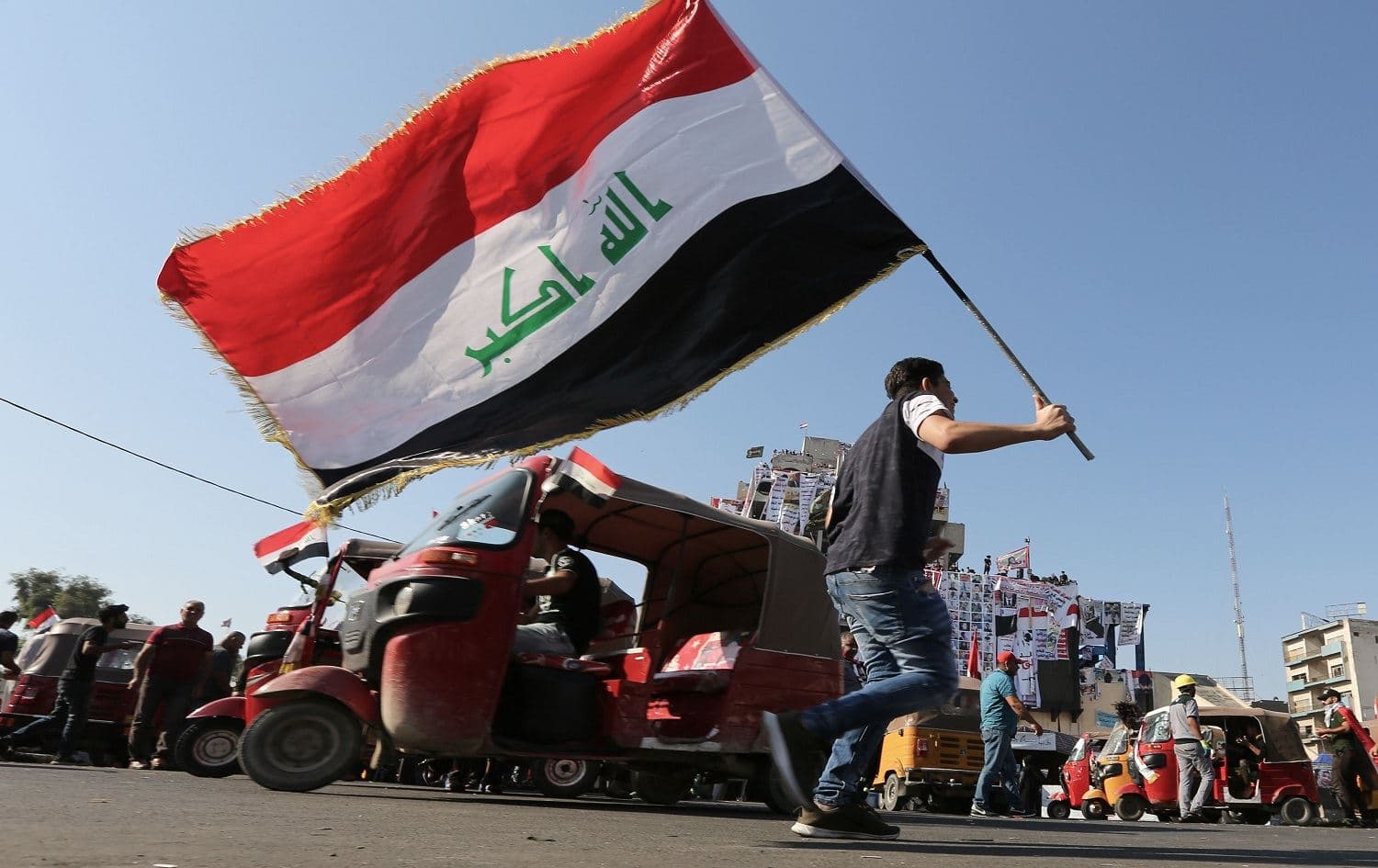 An Iraqi protester waves the natioanl flag in Tahrir square in the capital Baghdad on November 5, 2019, amid ongoing anti government demonstrations. Photo: Sabah Arar/AFP
