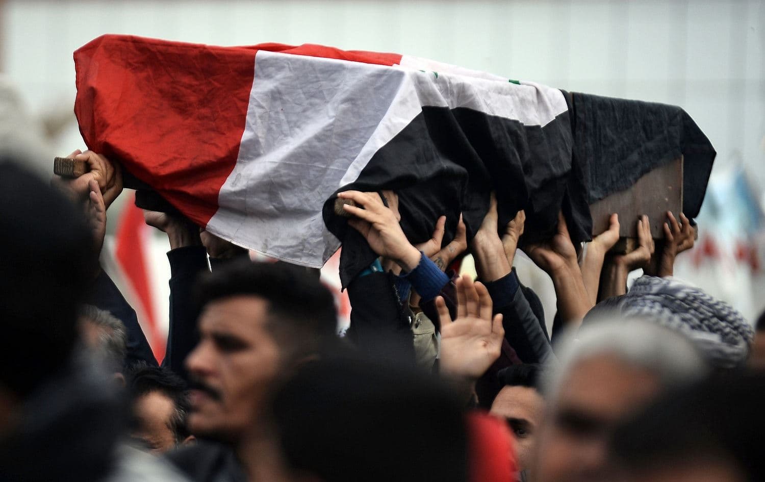 Young Iraqis carry the coffin of an anti-government demonstrator killed during protests a day earlier, during a funeral procession in the central holy shrine city of Najaf, November 29, 2019. Photo: Haidar Hamdani / AFP