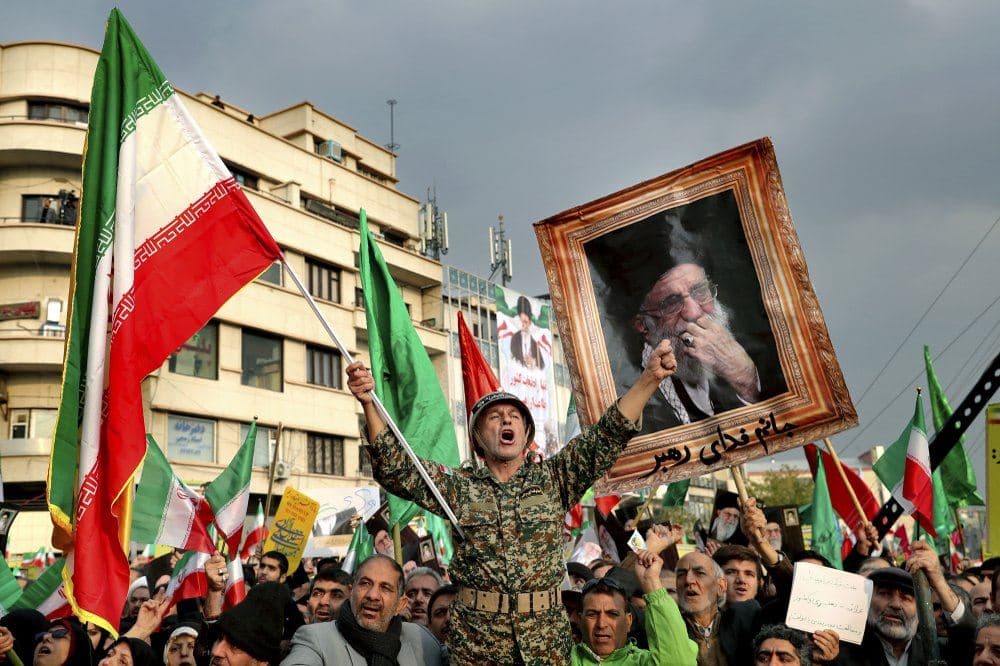 In a Nov. 25, 2019, file photo, a demonstrator chants slogans while holding up an Iranian national flag during a pro-government rally in Tehran, Iran, denouncing violent protests over a government-imposed fuel price hike. (AP Photo/Ebrahim Noroozi, File)