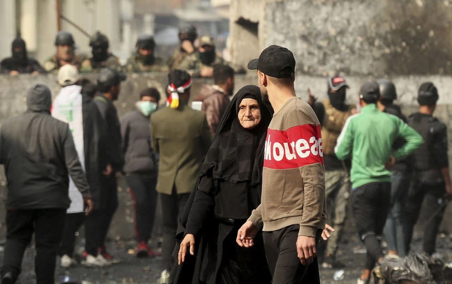 Anti-government protesters gather during clashes with security forces on Rasheed Street in Baghdad, Iraq, Friday, Dec. 6, 2019. (AP Photo/Hadi Mizban)