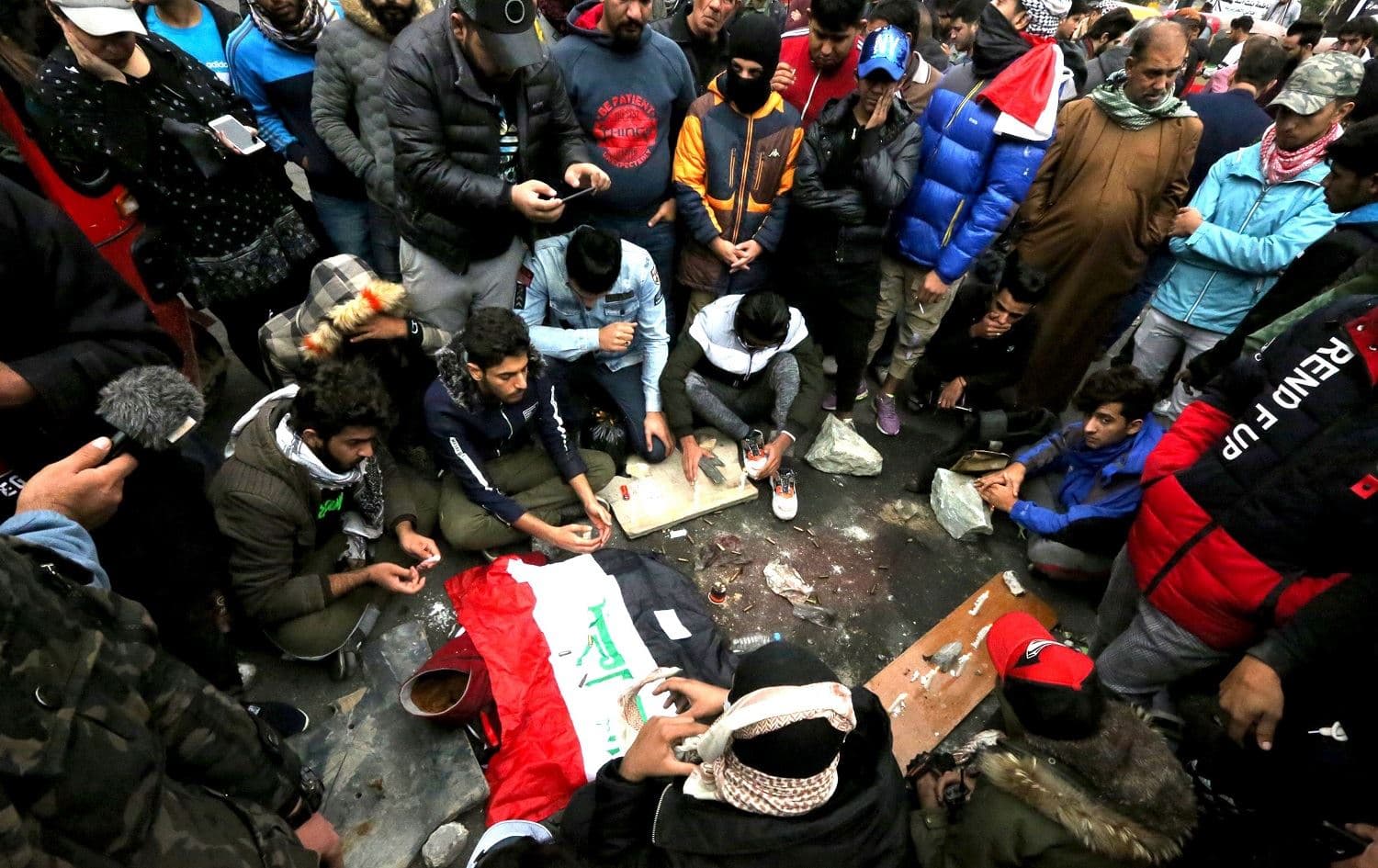Iraqi protesters mourn and pray at the site where 17 people at least were killed and dozens more wounded in Khilani Square in Baghdad on December 7, 2019. Photo: Sabah Arar / AFP